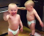 twin boys Sam and Ren appear to be having a grown-up conversation complete with questions, answers, facial expressions and gestures 